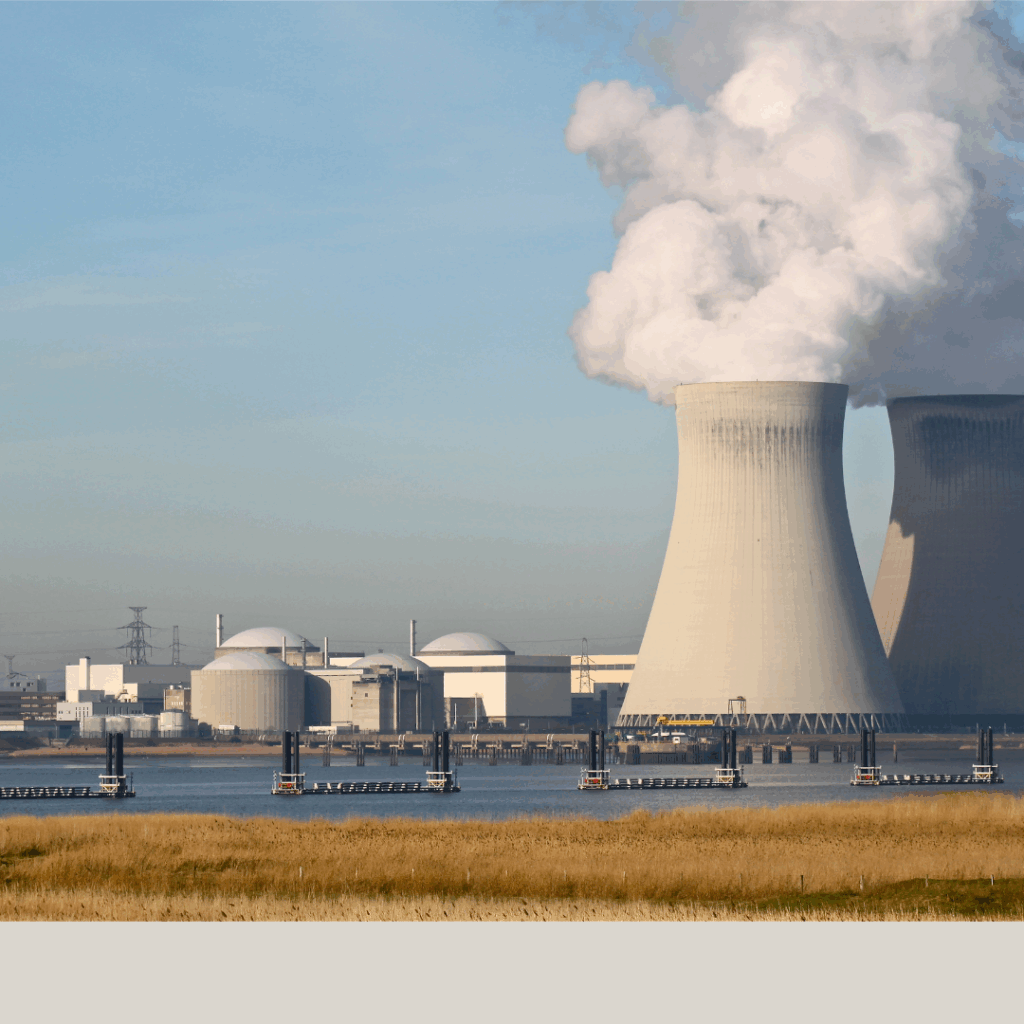 a nuclear power plant with smoke coming out of the chimney